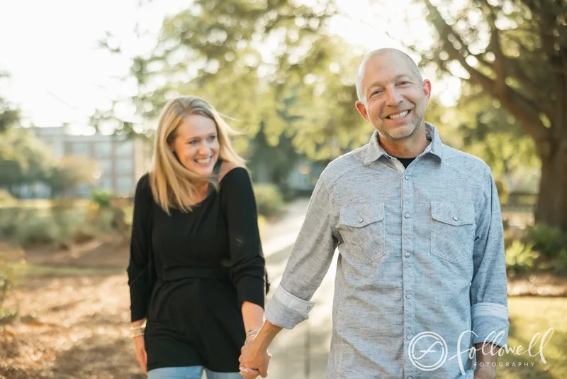 The podcast hosts walking hand-in-hand outdoors
